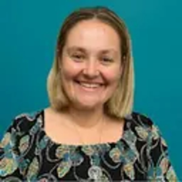 Alicia Pont, Learning Development and Practice Support, smiling at the camera wearing a patterned top